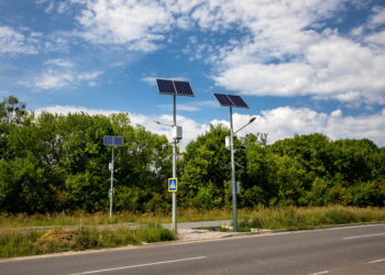 Solar panels above the highway to illuminate the road. Renewable energy with the help of the sun.