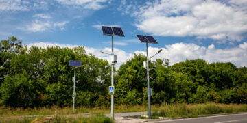 Solar panels above the highway to illuminate the road. Renewable energy with the help of the sun.